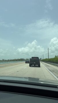 Key Largo, Florida, USA, June 28, 2025: SLOW MOTION SHOT - Driving on US 1 Overseas Hwy to the Florida Keys. Traffic on Overseas Highway US 1.