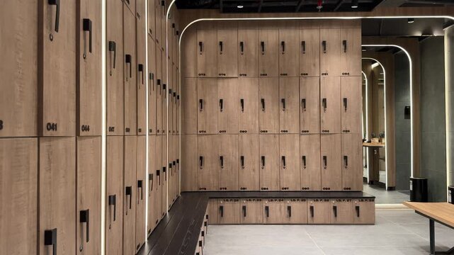 high-end locker room with warm wooden lockers, soft lighting, and bench seating, designed for gyms, spas, and luxury wellness facilities. ideal for themes of fitness lifestyle, resort amenities