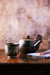 Fototapeta premium Traditional japanese ceramic on rustic wooden background. Soft focus. Copy space.