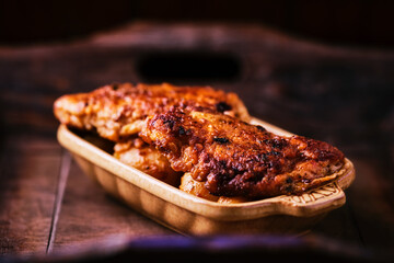  Fried chicken breast with potatoes. Rustic wooden background. Soft focus.