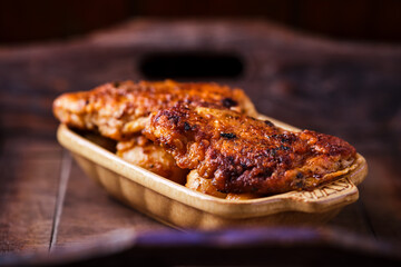  Fried chicken breast with potatoes. Rustic wooden background. Soft focus.