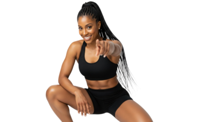 Strong African American fitness woman pointing to you with confident smile, ready to motivate and inspire workout goals
