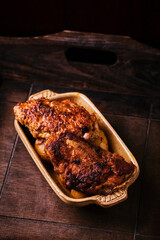Fried chicken breast with potatoes. Rustic wooden background. Soft focus.