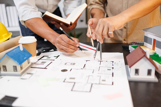 
Two people are working on a house plan design. They are using various tools, working with the plan, and reviewing a house model to verify the accuracy of their work in the workplace.

 - Powered by Adobe