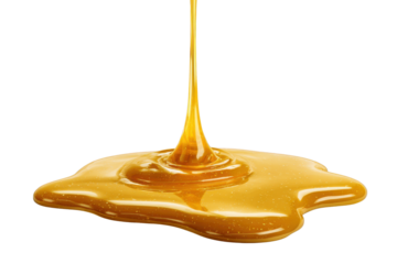 Golden honey liquid pouring and spreading on black background yellow