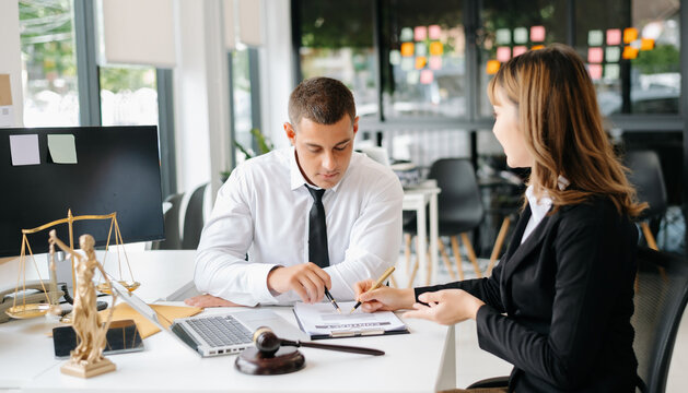 Professional lawyer consulting a client about legal contract in modern office, law and justice concept, business agreement, legal advice