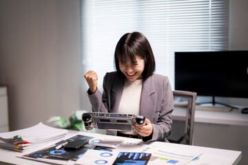 Businesswoman celebrating winning game while relaxing during work break