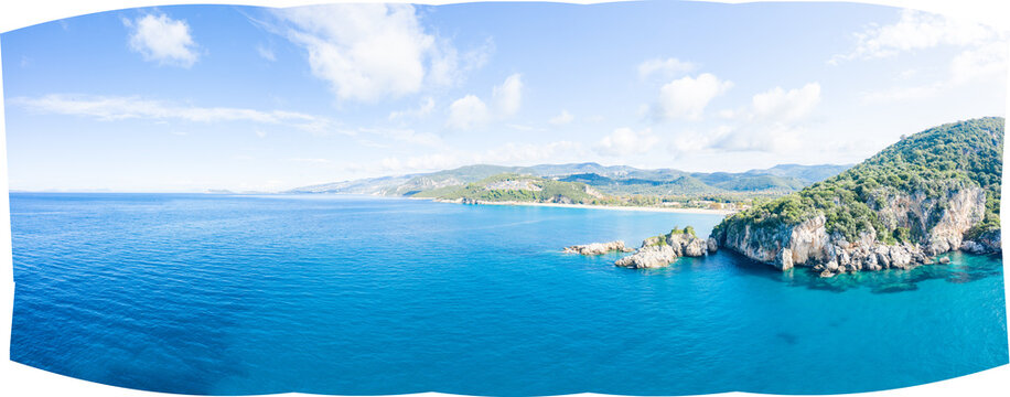 Sweeping panorama of the Karavostasi coastline in Epirus, Greece, featuring deep blue water, rocky cliffs, and lush green hills under a bright sky. The clear Ionian Sea contrasts with the rugged - Powered by Adobe