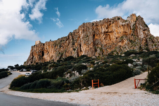Torre Isulidda Near San Vito Lo Capo In Sicily: Historic Coastal Watchtower With Rugged Limestone Mountains And Southern Rock Climbing Cliffs In Natural Mediterranean Landscape
