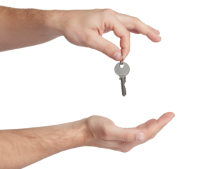 A hand is holding a key above another outstretched hand, symbolizing the act of giving or transferring ownership.