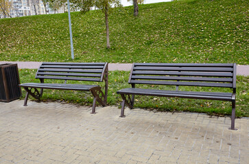 Rest area with benches surrounded by trees at Autumn in Kyiv, Europe. Place to rest in the city park