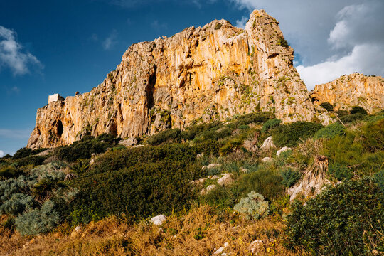 Aerial View of Torre Isulidda Near San Vito Lo Capo In Sicily: Historic Coastal Watchtower With Rugged Limestone Mountains And Southern Rock Climbing Cliffs In Natural Mediterranean Landscape
