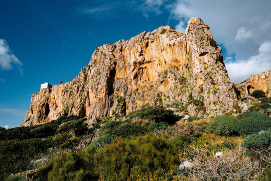 Torre Isulidda Near San Vito Lo Capo In Sicily: Historic Coastal Watchtower With Rugged Limestone Mountains And Southern Rock Climbing Cliffs In Natural Mediterranean Landscape