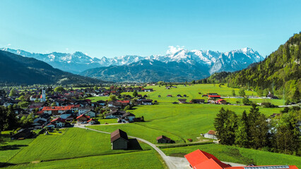 Green meadows and colorful houses © AlexGo