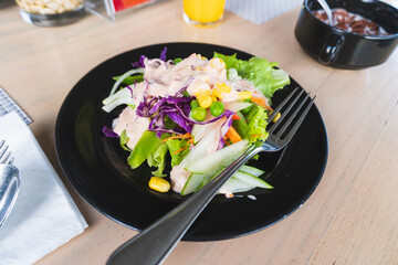 A simple vegetable salad with assorted vegetables, corn, and mayo dressing.