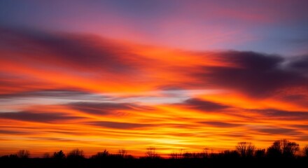 Obraz premium Vibrant sunset sky with streaks of orange and purple colors