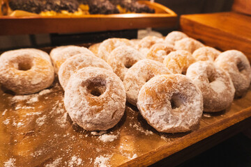 Donuts with sugar powder in coffee shop.