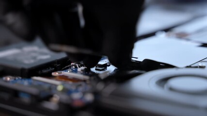 Close-up of a technician using a screwdriver to repair an electronic device. Scene shows precision hardware maintenance, electronics service, and professional technical work.