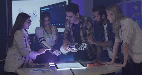 Diverse group of engineers and designers collaborates on development of robotic prosthetic arm in high-tech innovation lab. Capturing teamwork, technological creativity, human-centered product design
- Powered by Adobe