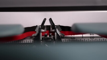 Close-up of a vintage typewriter mechanism printing the words story of my life on the paper. Moving metal parts and classic design create a nostalgic retro writing atmosphere.