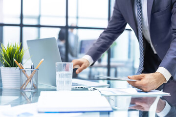 Business person analyzing financial statistics displayed on the tablet screen.