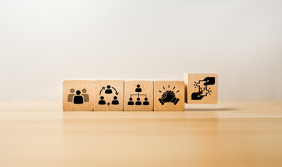 Wooden blocks displaying icons of teamwork, collaboration, organizational structure, leadership,...
