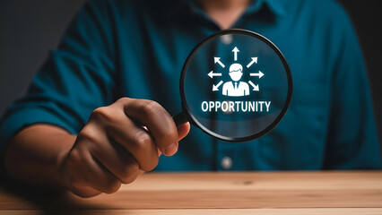 Magnifying glass focuses on a glowing business icon showing multiple paths representing career or market opportunity in a dimly lit setting.