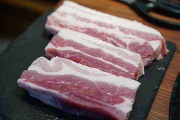 Fresh raw pork belly slices for cooking, perfect for Korean barbecue or roasting