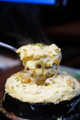 Fluffy Korean steamed egg (Gyeran-jjim) in a hot stone pot, a traditional side dish