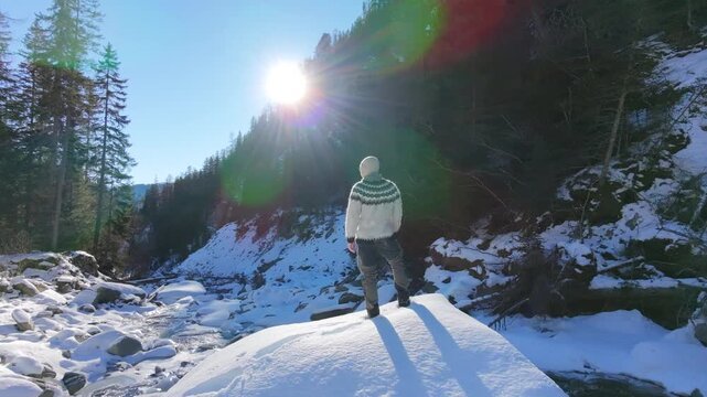 Drone Orbit Shot of Person Standing in Snowy Riverbed