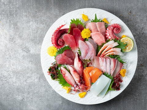 A variety of raw fish and seafood on a plate