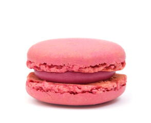Pink macarons filled with strawberry butter cream closed up isolated on white
