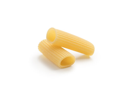 Italian dry rigatoni pasta over white background with shadow