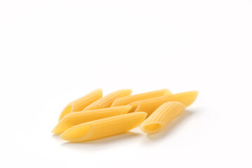 Italian dry penne rigate pasta over white background with shadow