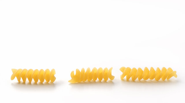 Italian dry fusilli pasta over white background with shadow