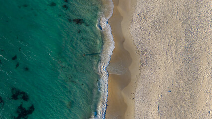 Aerial top down drone view of people walking along the beach in Perth Western Australia and swimming in the ocean © Michael