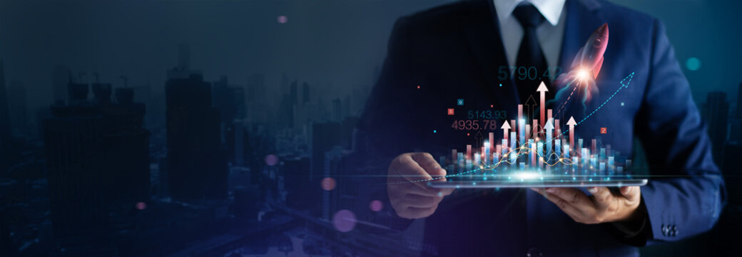 Businessman holding Startup rocket launch growth graph of business on tablet achieving goals with the rising arrow, Business strategy development and planning of successful.