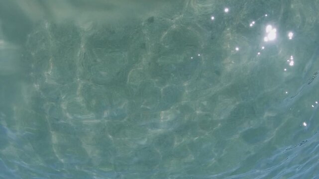 Blue water with rays of sunlight illuminating underwater. Footage taken by a go pro. Summer time in New Zealand.