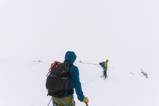Skiers travel over glaciers in the backcountry of Canada.