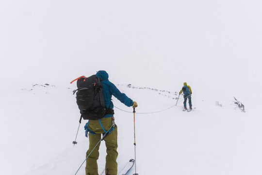 Skiers travel over glaciers in the backcountry of Canada.