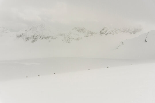 Skiers travel over glaciers in the backcountry of Canada.