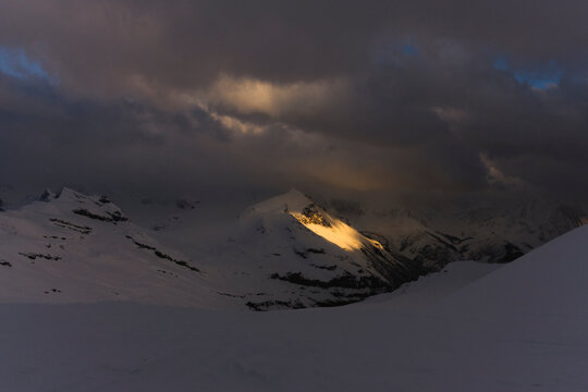 Light illuminates a mountain in the Northern Rockies of Canada.