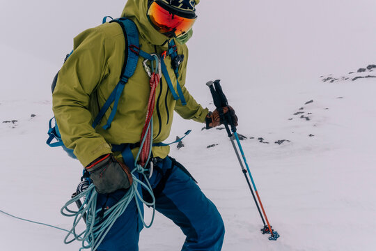 A skier carries a rope during a backcountry ski trip.
