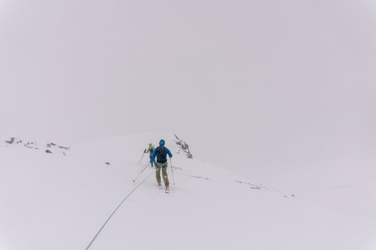 Skiers travel over glaciers in the backcountry of Canada.