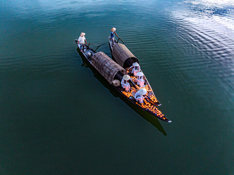 Women on boat with traditional lanterns, Vietnam