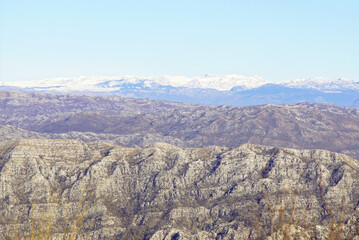 View from the Orjen Nature Park to the snow-covered Durmitor. Represents raw geology, Balkan wilderness, climate shaped terrain, hiking culture in Montenegro, and dramatic European alpine landscapes.