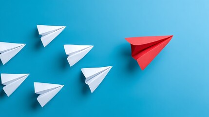 Formation of white paper airplanes following red paper airplane on a blue background, concept for business leadership, strategic planning and innovative solution.
