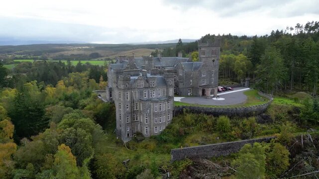 carbisdale castle from perspective architecture surrounding forest located highlands scotland circling aerial drone kyle sutherland scenic nature landscape exploration journey outdoor 