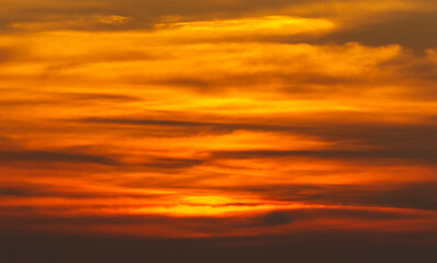 Obraz premium A sunset with orange clouds in the sky