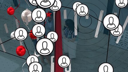 Animation of data processing and christmas decorations over business people in office - Powered by Adobe